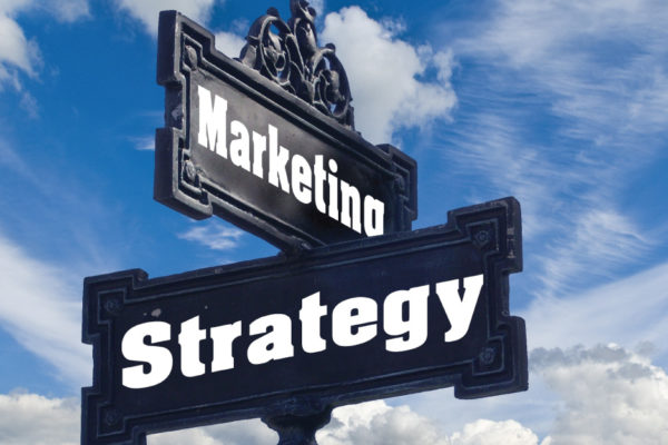 A signage with the words marketing and strategy